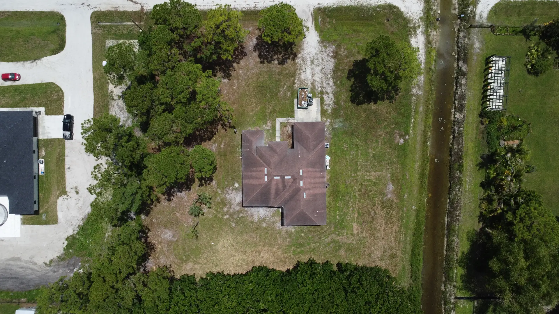 Straight-down aerial view of a home and surrounding property