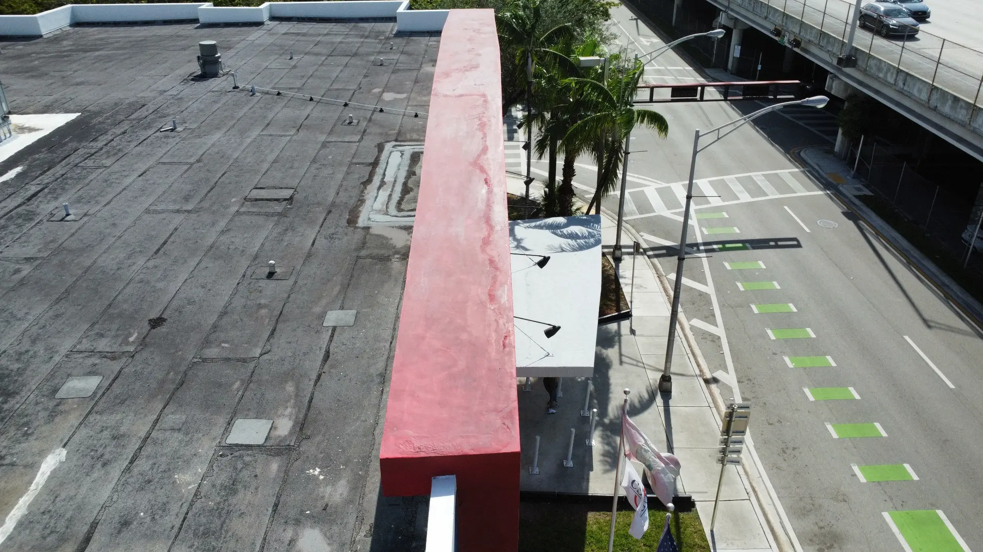 Elevated drone view beside a downtown building and roadway