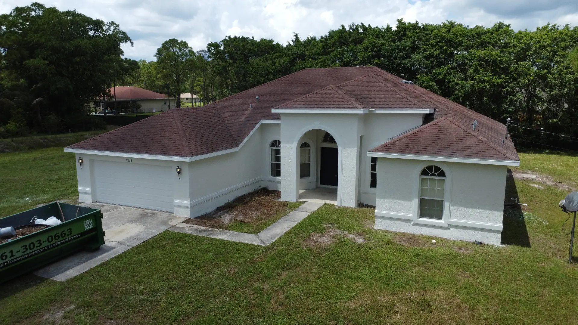 Drone view of a white home from the front